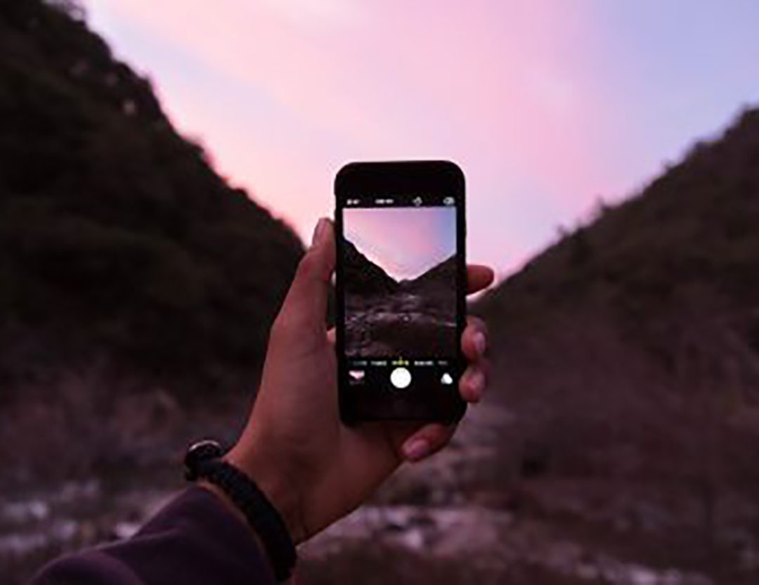 View of a phone camera taking photo of desert scenery