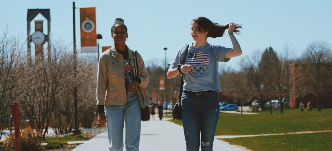 two college students walking on campus