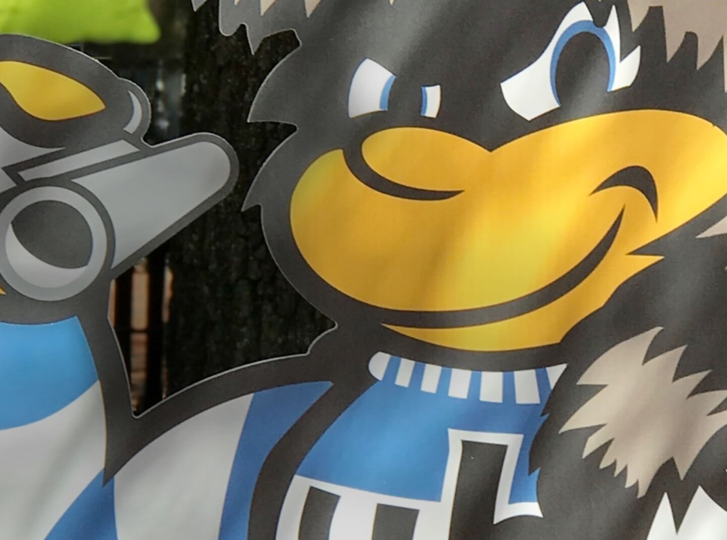 Cutout illustration of the University of Baltimore bee mascot holding binoculars, part of the event decorations for Gamescape designed by idfive