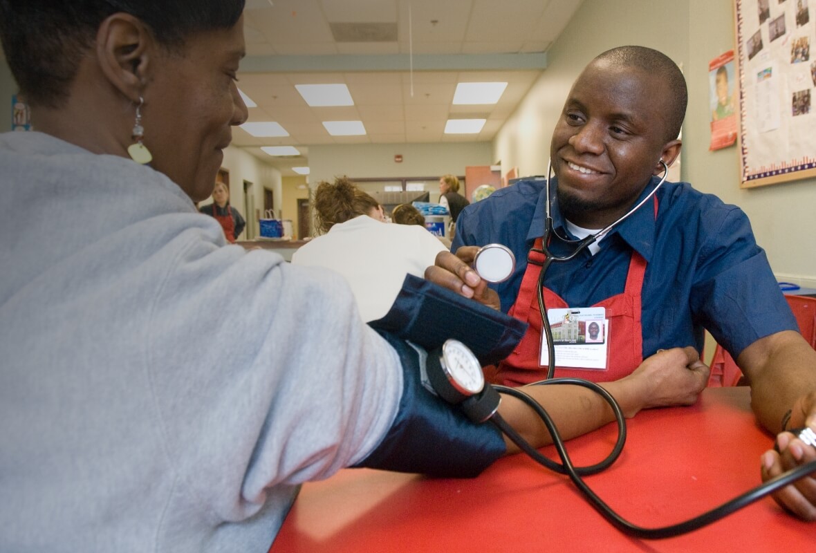 A University of Maryland School of Nursing student performs a blood pressure test at a community clinic