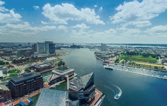 Aerial view of Baltimore Harbor as a water taxi slowly circles around the National Aquarium