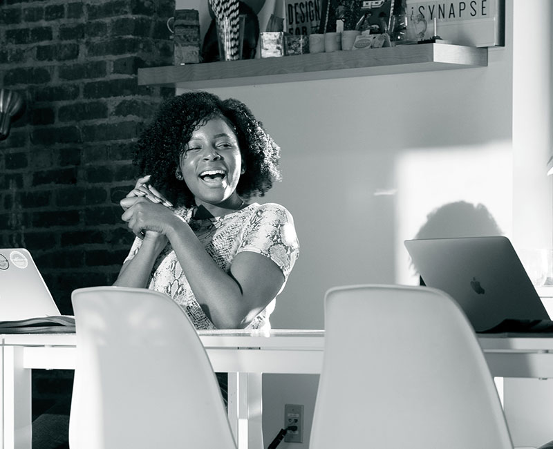 woman smiling while sitting at table