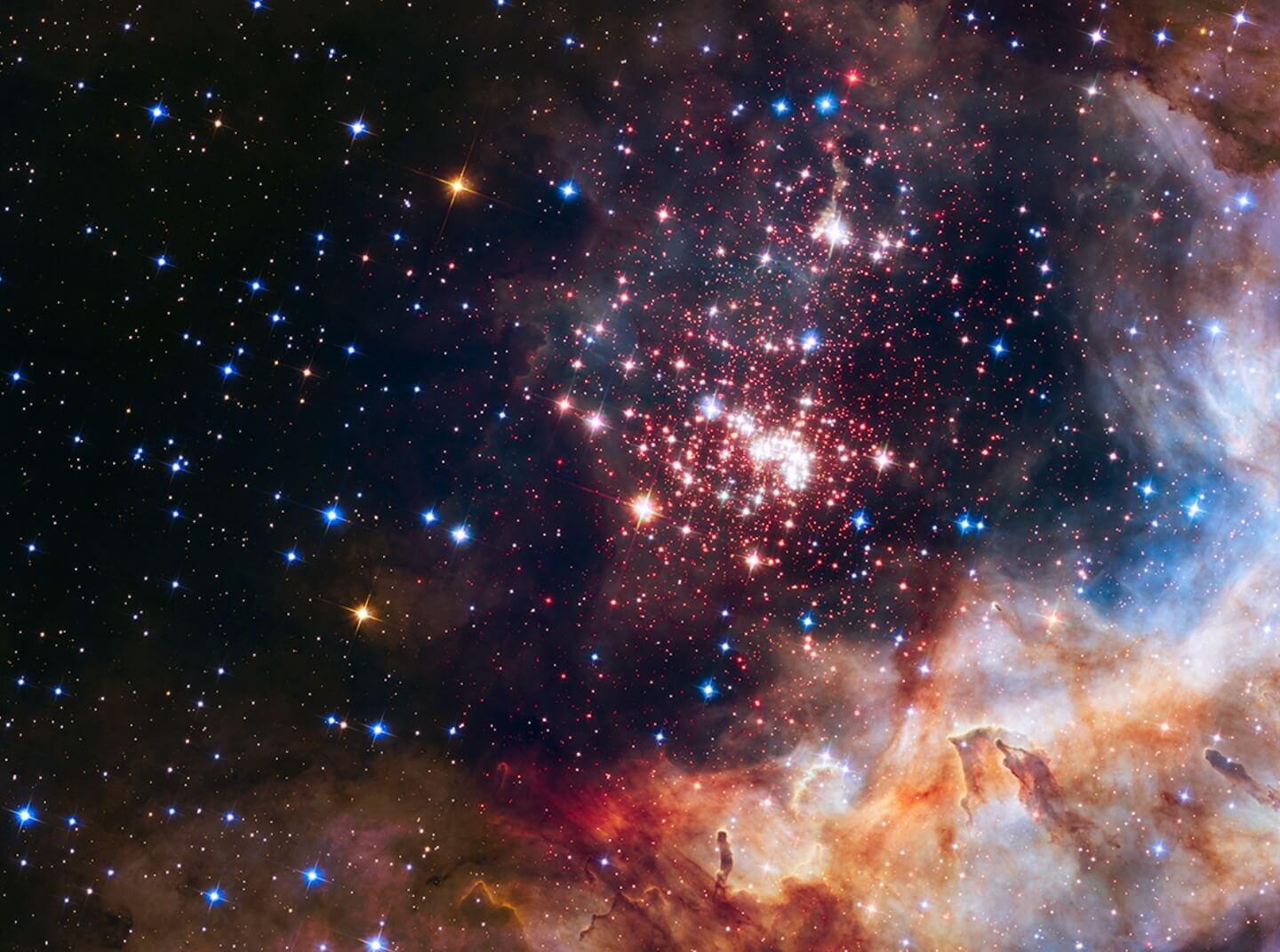 Deep space photograph displays a distant star cluster and nebula
