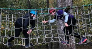 Two idfivers pretend battle on a ropes course.