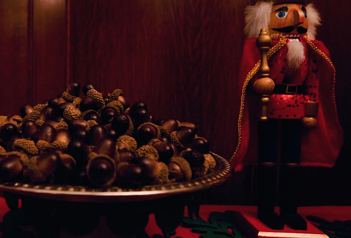 Close up of acorns on a tray, nutcracker in the background