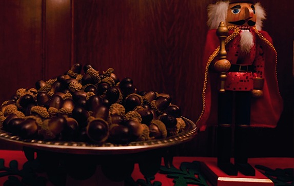 Close up of acorns on a tray, nutcracker in the background