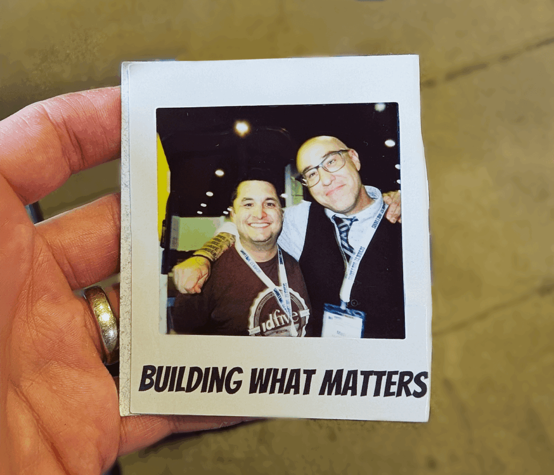 Fiver Sean holding a photo of Fiver Matt and him at the Bridge Conference.